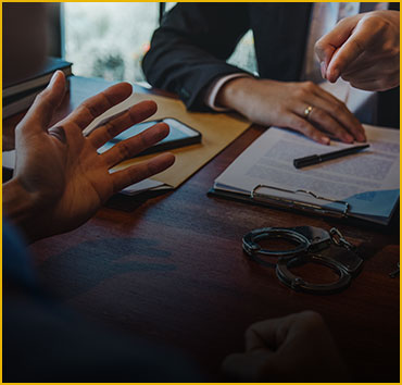 Hands discussing legal documents: Probation and parole violations.