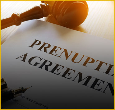 Gavel on a 'PRENUPTIAL AGREEMENT' document, representing pre-nuptial agreements.
