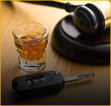 Whiskey glass, car keys, and gavel: DWI and DUI defense legal services.