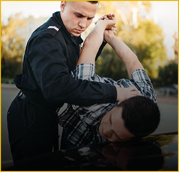 Police officer arresting a person, for violent crimes.