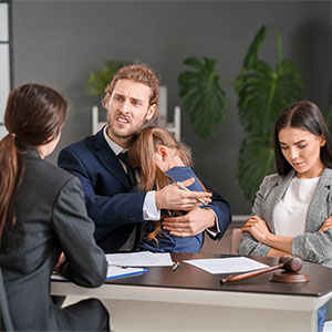 Family and lawyer in a legal meeting, symbolizing custody & visitation cases.