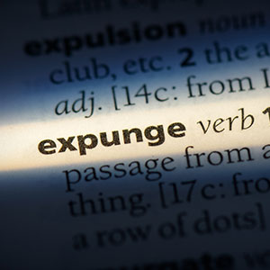 Dictionary with the word "expunge" highlighted, for an expungement attorney.