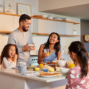 A diverse family enjoying breakfast together, symbolizing family law services.