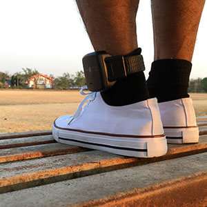 Ankle monitor on a person's leg, symbolizing probation and parole violations.