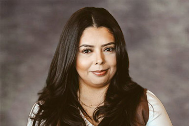 Professional portrait of Legal Assistant Sandra Castillo in a brown vest.