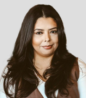 Professional portrait of Legal Assistant Sandra Castillo in a brown vest.