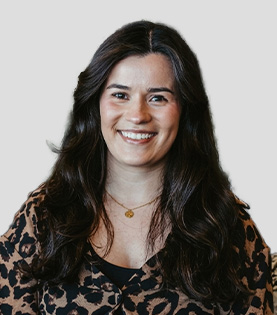Legal Assistant Victoria Rowe smiling in a leopard print blouse.