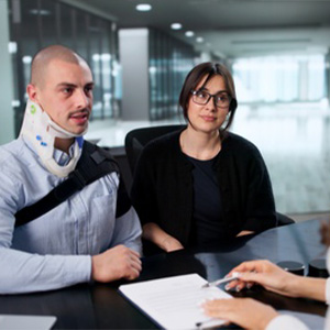 Injured client meeting personal injury lawyer for legal consultation